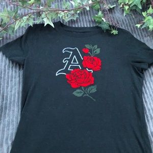 Black tee with a "A" on it and roses